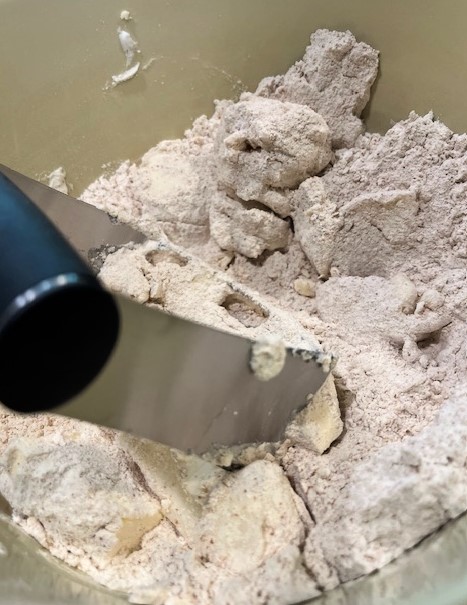 Pastry cutter in a bowl with flour and butter