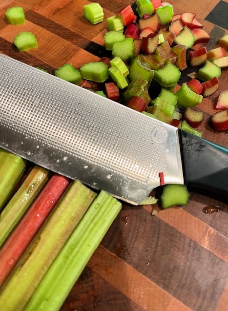 Rhubarb on a cutting board with a knife