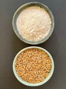 bowl of wheat berries and bowl of flour