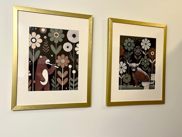 two pictures in gold frames hung on the wall