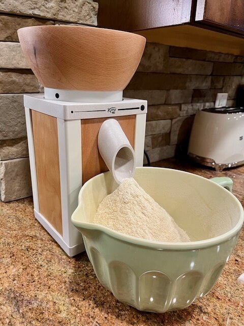 Troubleshooting Freshly Milled Flour showing a stone mill with fresh flour coming out