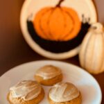 Three Pumpkin Cookies freshly milled flour on a white plate with a pumpkin in the background.