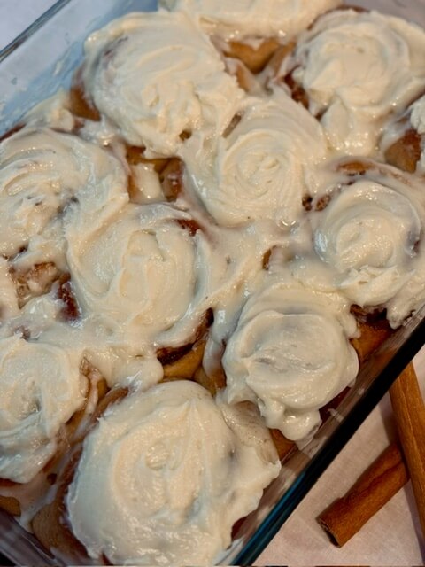 9x13 pan of fresh milled flour cinnamon rolls that are frosted