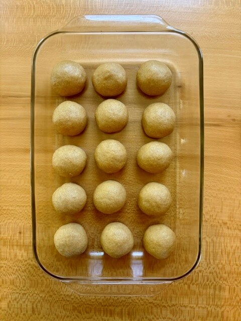 Hawaiian rolls with fresh milled flour that are shaped and waiting to do the second rise in a 9x13 pan