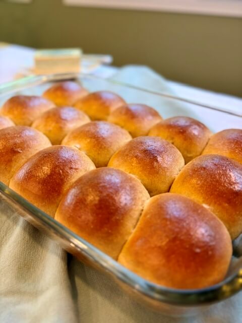 Hawaiian rolls with fresh milled flour in a 9x13 pan. Cooked and golden brown