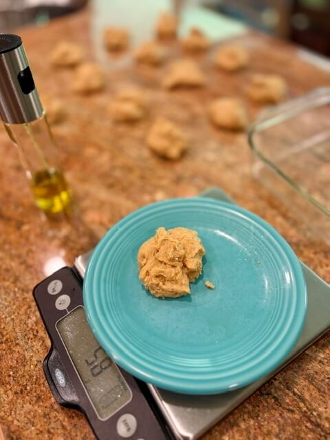 one Hawaiian roll with fresh milled flour on a scale waiting to be shaped
