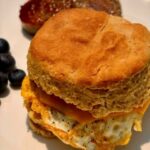 fresh milled flour biscuit made into an egg sandwich on a white plate