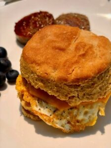 fresh milled flour biscuit made into an egg sandwich on a white plate