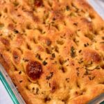 Fresh Milled Focaccia in a pan on a white tablecloth