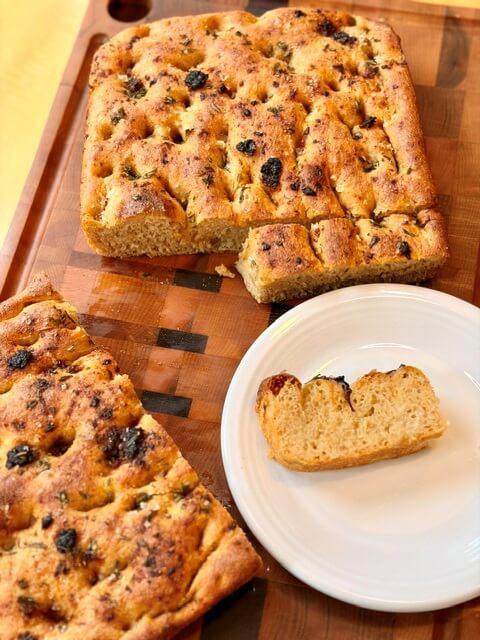 Fresh Milled Flour Focaccia on a white plate and cutting board