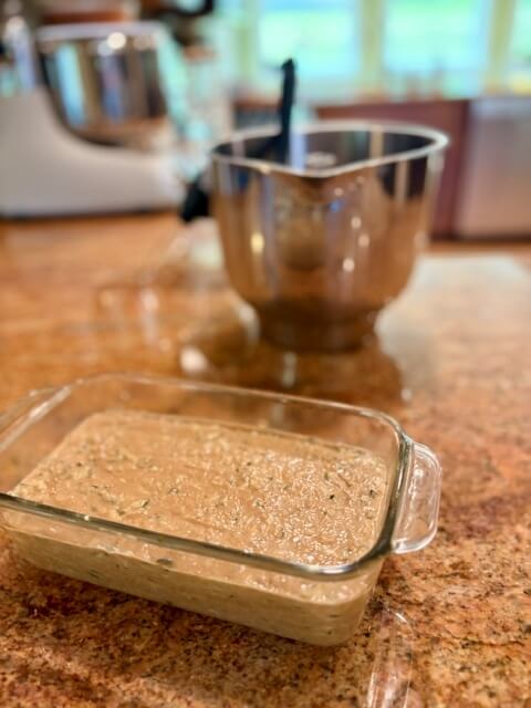 fresh milled flour zucchini bread batter in glass loaf pan
