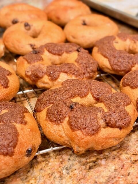 Cinnamon Raisin crunch fresh milled flour bagels on a wire rack