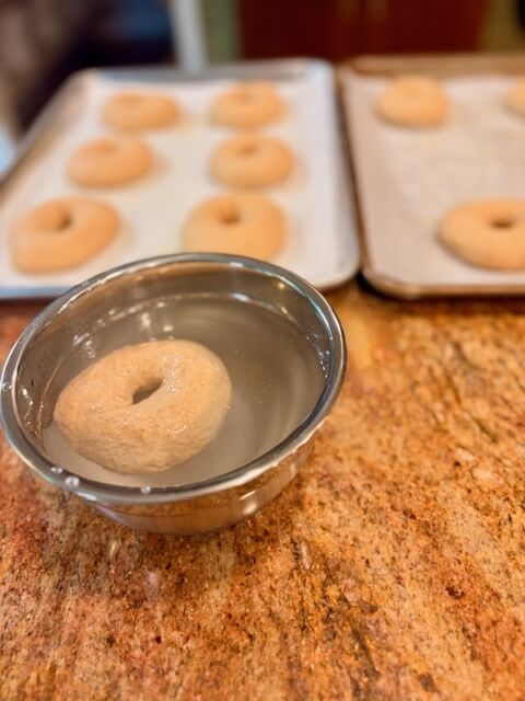 a fresh milled flour bagels floating in a bowl of water