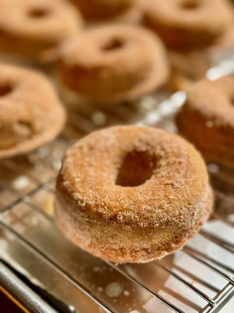 fresh milled flour apple cider donuts on a wire rack