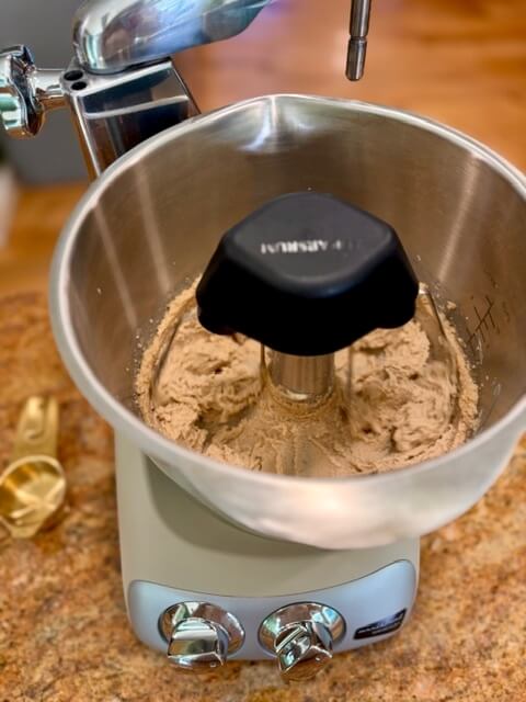 butter and sugar being creamed together in the bowl of a ankarsrum mixer